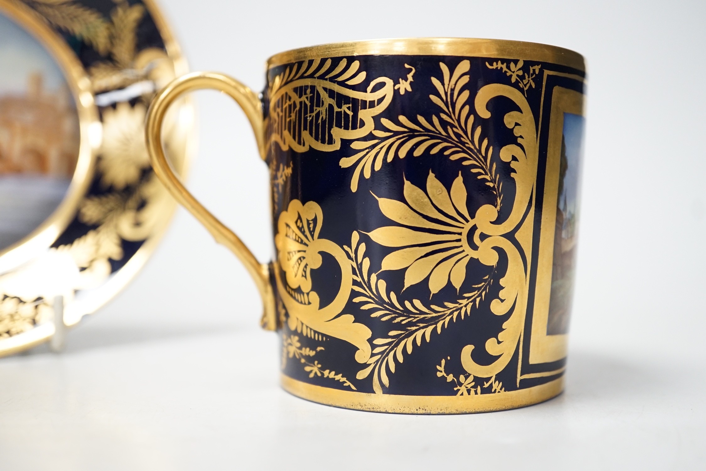 A Continental Derby style cup and saucer, 8cm tall overall